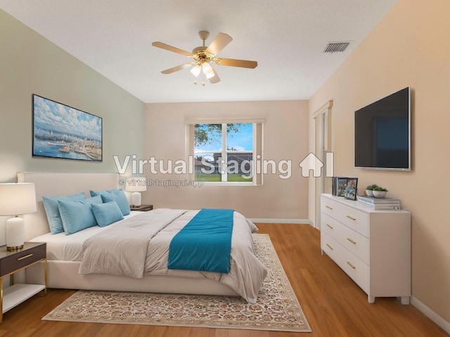 bedroom featuring baseboards, light wood finished floors, and a ceiling fan