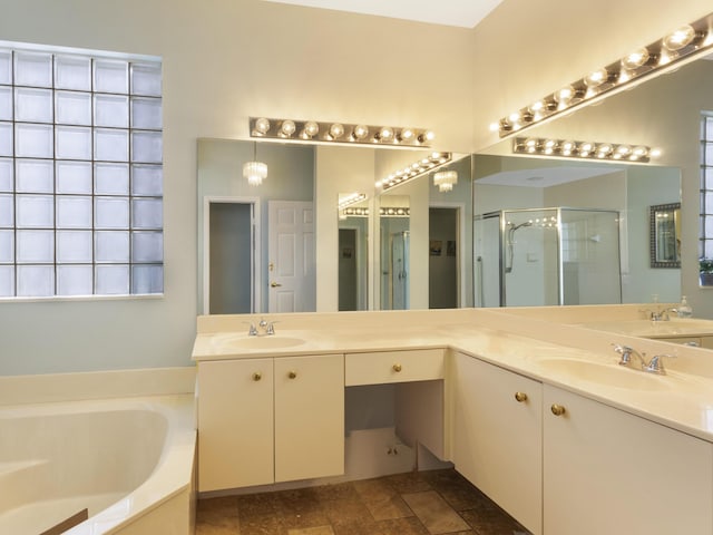 bathroom with a garden tub, a shower stall, and vanity