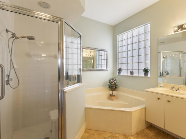 full bath with a stall shower, a bath, and vanity
