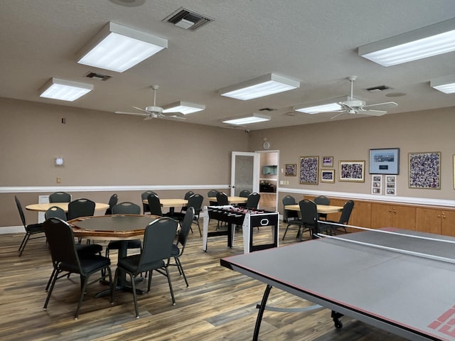 rec room with ceiling fan and wood finished floors