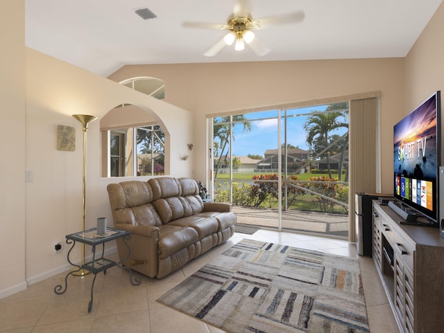 living area featuring light tile patterned floors, lofted ceiling, and ceiling fan