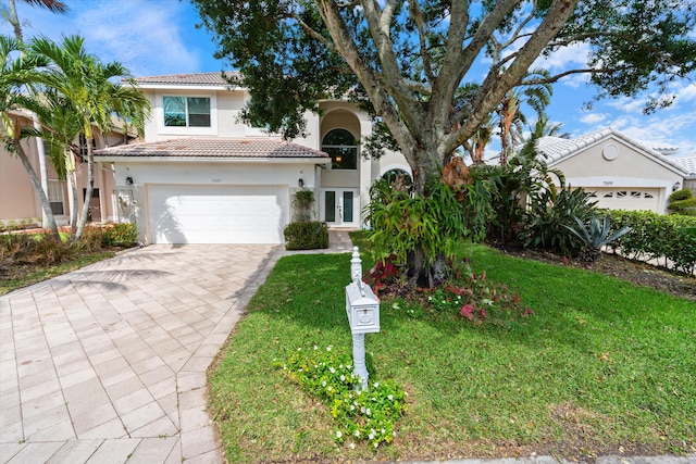 view of front of home with french doors, a tiled roof, stucco siding, and decorative driveway