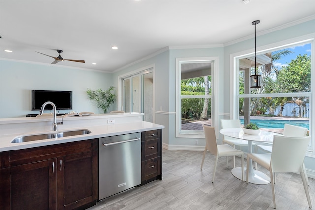 kitchen with dishwasher, a sink, dark brown cabinetry, light countertops, and baseboards
