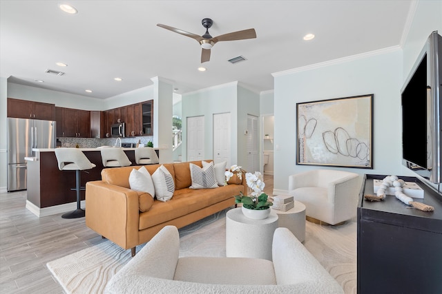 living room with ornamental molding, ceiling fan, recessed lighting, and baseboards