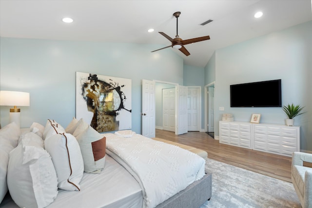 bedroom featuring light wood-style flooring, high vaulted ceiling, recessed lighting, ceiling fan, and baseboards