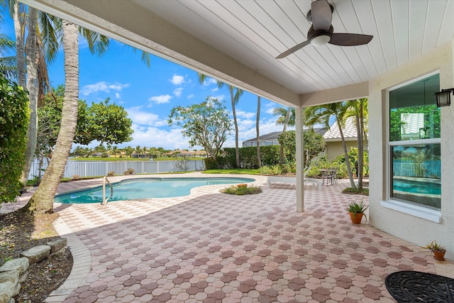 view of pool with a patio, a ceiling fan, and a fenced backyard