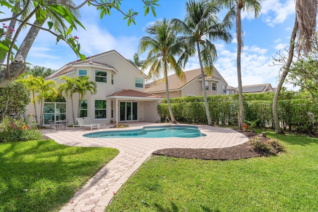 view of swimming pool with a patio area and a yard
