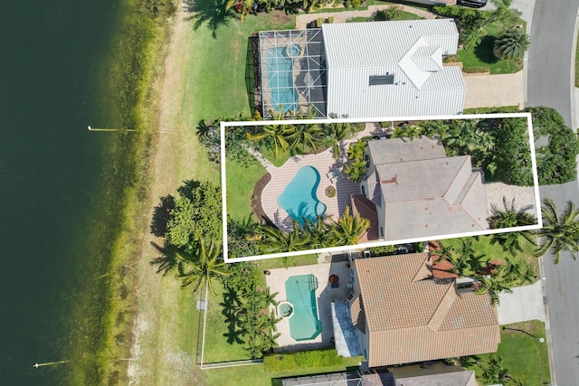 aerial view of property and surrounding area featuring a pool area and property parcel outlined
