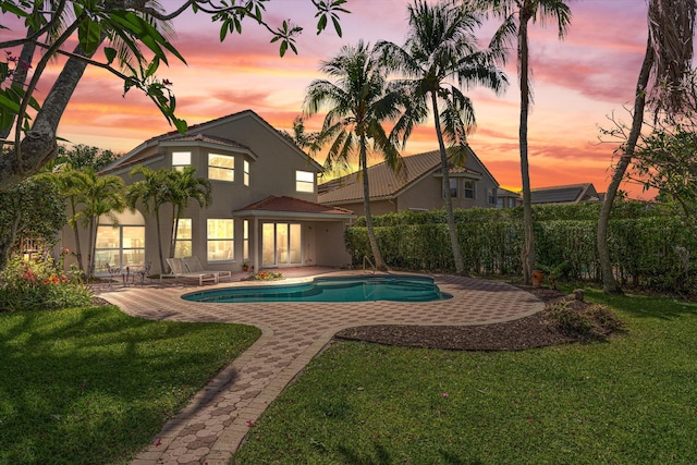 view of swimming pool featuring a yard and a patio