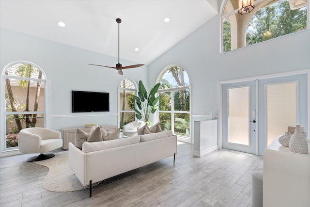 living area featuring high vaulted ceiling, wood finished floors, and recessed lighting