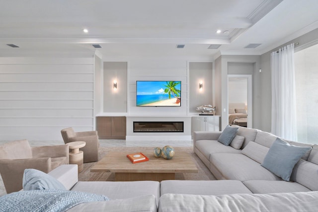 living area featuring ornamental molding, recessed lighting, and a glass covered fireplace