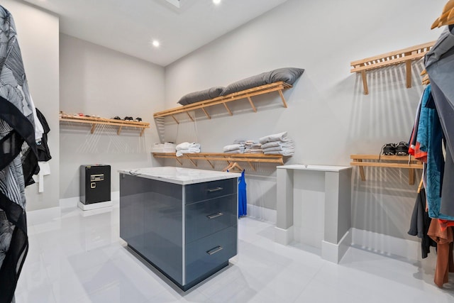 spacious closet with light tile patterned floors