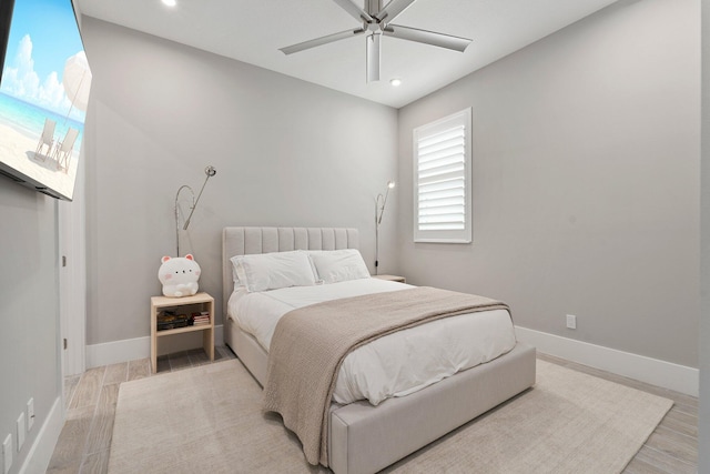 bedroom featuring baseboards, recessed lighting, light wood-style flooring, and ceiling fan