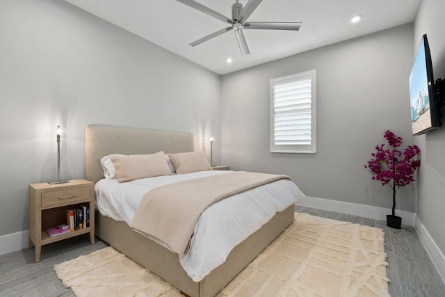 bedroom with baseboards, recessed lighting, wood finished floors, and ceiling fan