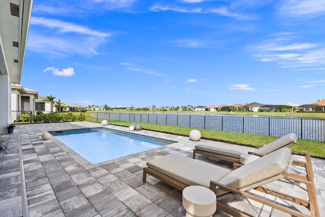 view of pool featuring a patio area, a residential view, a fenced backyard, and a water view