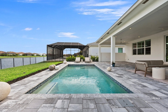 view of swimming pool featuring a ceiling fan and a patio