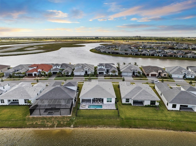aerial perspective of suburban area with a nearby body of water