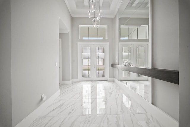 entryway featuring french doors, a towering ceiling, baseboards, marble finish floors, and a raised ceiling