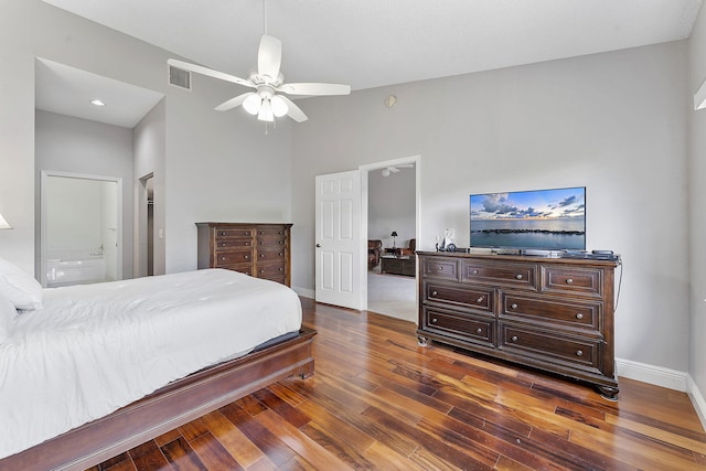 bedroom with wood-type flooring, baseboards, a towering ceiling, ensuite bathroom, and ceiling fan