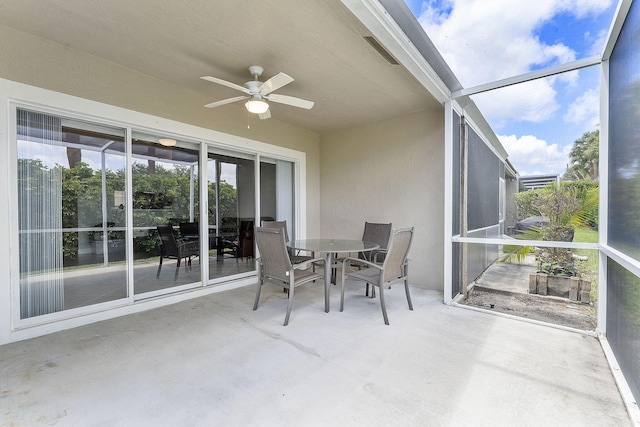 sunroom with a ceiling fan and outdoor dining area