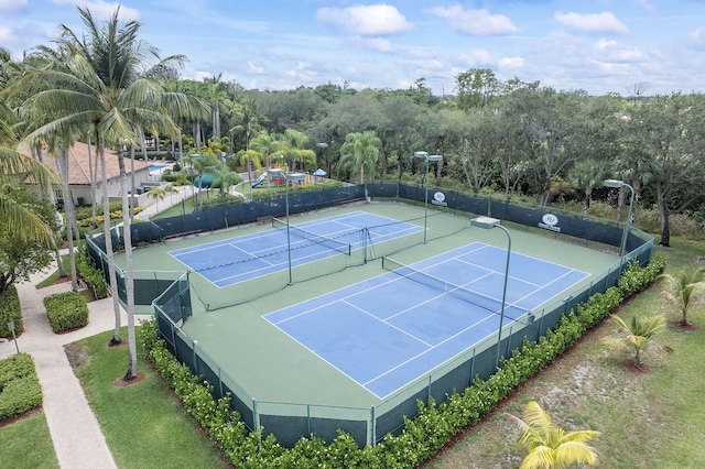 view of tennis court featuring fence