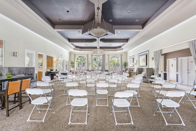 building lobby featuring a towering ceiling and coffered ceiling