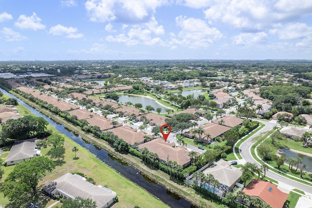 aerial view of property's location with nearby suburban area and a nearby body of water