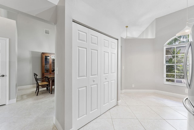 interior space featuring light tile patterned floors and baseboards