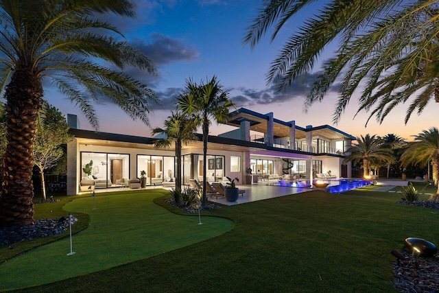 4460 NE 31st Ave, Lighthouse Point, FL 33064 - back of house with a putting green, a balcony, outdoor lounge area, a patio, and an outdoor pool