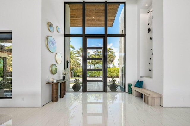 4460 NE 31st Ave, Lighthouse Point, FL 33064 - doorway to outside with floor to ceiling windows and a high ceiling