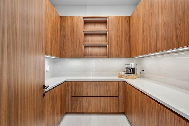 4460 NE 31st Ave, Lighthouse Point, FL 33064 - kitchen with brown cabinetry, light countertops, and modern cabinets
