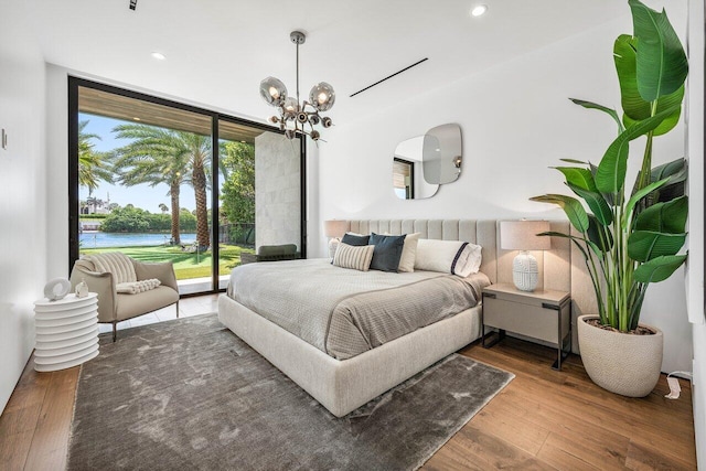 4460 NE 31st Ave, Lighthouse Point, FL 33064 - bedroom featuring a chandelier, wood finished floors, access to exterior, recessed lighting, and a water view