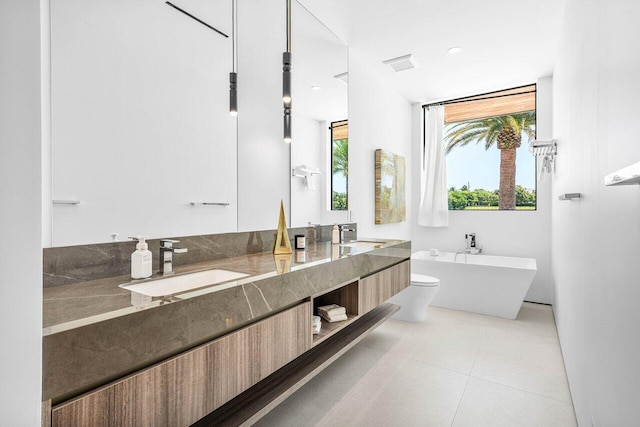 4460 NE 31st Ave, Lighthouse Point, FL 33064 - bathroom featuring double vanity, a freestanding tub, toilet, and tile patterned flooring