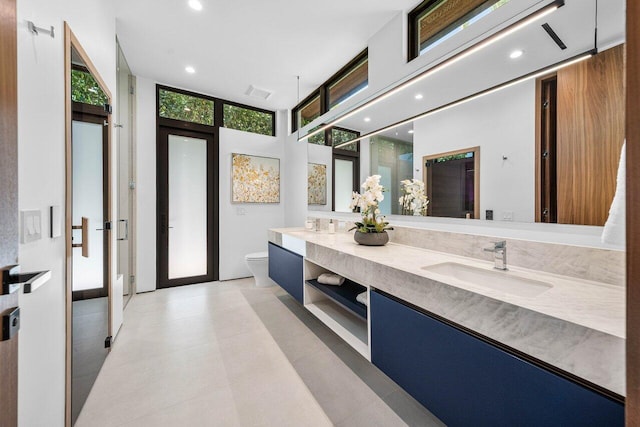 4460 NE 31st Ave, Lighthouse Point, FL 33064 - full bathroom featuring double vanity, toilet, recessed lighting, and an enclosed shower