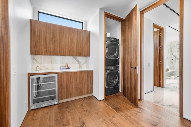4460 NE 31st Ave, Lighthouse Point, FL 33064 - laundry area with wine cooler, estacked washer and dryer, and light wood-style floors