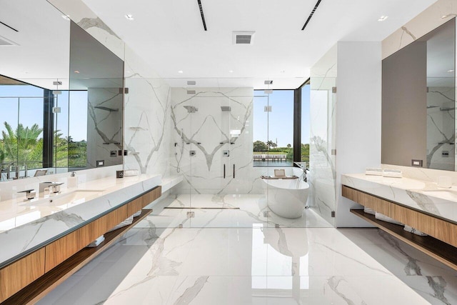 4460 NE 31st Ave, Lighthouse Point, FL 33064 - bathroom featuring marble tiled floors, plenty of natural light, a soaking tub, and a marble finish shower