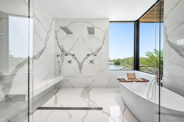 4460 NE 31st Ave, Lighthouse Point, FL 33064 - bathroom with a freestanding bath, marble tiled flooring, a water view, and a marble finish shower