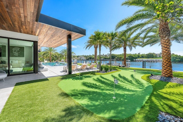 4460 NE 31st Ave, Lighthouse Point, FL 33064 - view of yard with a putting area, a patio area, a water view, and an outdoor pool