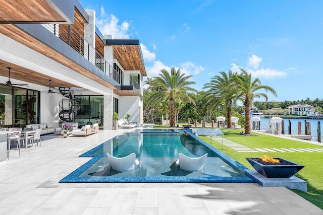 4460 NE 31st Ave, Lighthouse Point, FL 33064 - swimming pool with an outdoor living space with a fire pit, a patio area, a water view, ceiling fan, and a lawn