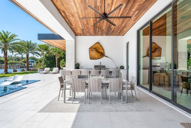 4460 NE 31st Ave, Lighthouse Point, FL 33064 - view of patio / terrace featuring exterior kitchen, outdoor dining area, a ceiling fan, and a water view