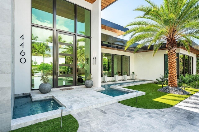4460 NE 31st Ave, Lighthouse Point, FL 33064 - property entrance with french doors, a patio area, and an outdoor pool