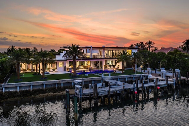 4460 NE 31st Ave, Lighthouse Point, FL 33064 - back of property at dusk with a water view, a balcony, a patio area, and a swimming pool