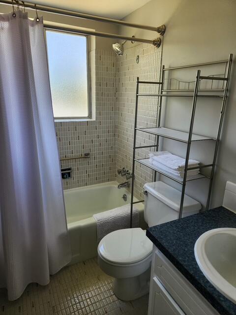 3362 Cynthia Ln Unit 211, Lake Worth Beach, FL 33461 - full bathroom with shower / bath combination with curtain, vanity, tile patterned flooring, and toilet