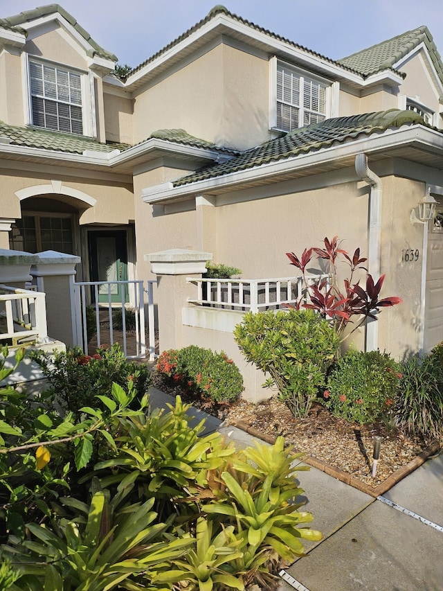 1639 SW Harbour Isles Cir Unit 29, Port Saint Lucie, FL 34986 - view of front of home featuring a tiled roof and stucco siding