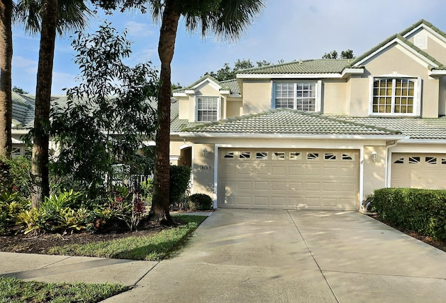 1639 SW Harbour Isles Cir Unit 29, Port Saint Lucie, FL 34986 - traditional-style home featuring a tile roof, an attached garage, concrete driveway, and stucco siding
