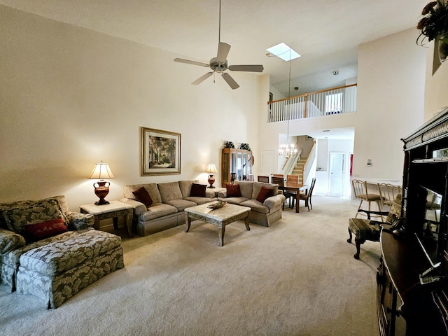 1639 SW Harbour Isles Cir Unit 29, Port Saint Lucie, FL 34986 - living area featuring light colored carpet, a towering ceiling, a chandelier, a ceiling fan, and a skylight