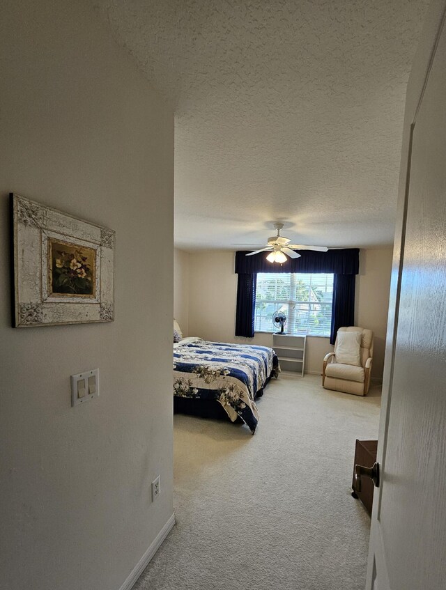 1639 SW Harbour Isles Cir Unit 29, Port Saint Lucie, FL 34986 - carpeted bedroom with baseboards, a ceiling fan, and a textured ceiling