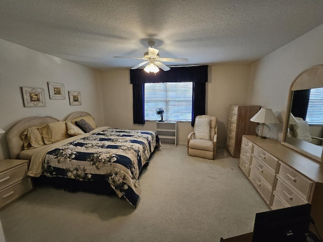 1639 SW Harbour Isles Cir Unit 29, Port Saint Lucie, FL 34986 - bedroom featuring light carpet, a ceiling fan, and a textured ceiling