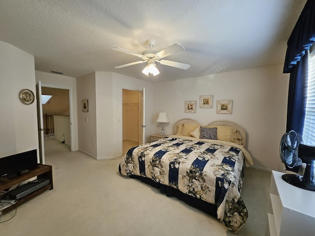 1639 SW Harbour Isles Cir Unit 29, Port Saint Lucie, FL 34986 - bedroom featuring light carpet, ceiling fan, baseboards, and a walk in closet