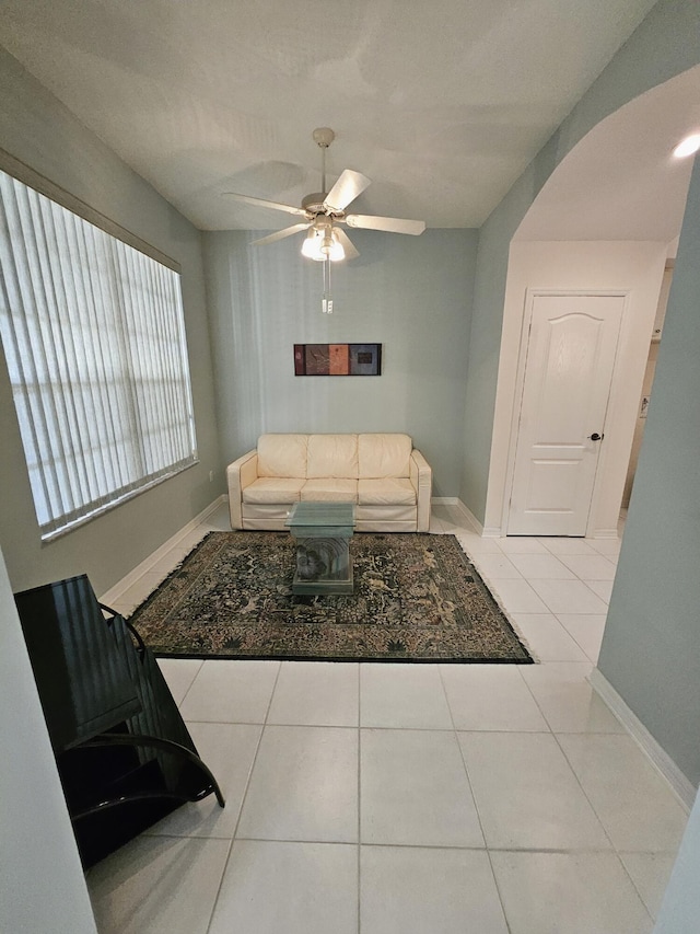 1639 SW Harbour Isles Cir Unit 29, Port Saint Lucie, FL 34986 - tiled living room featuring a ceiling fan, arched walkways, and baseboards
